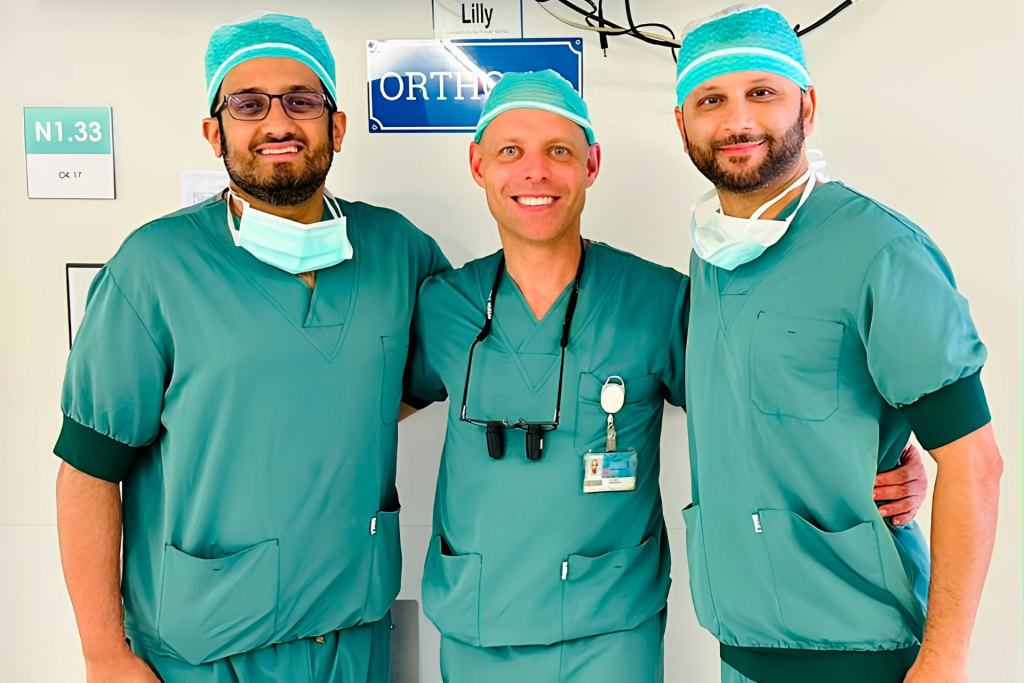 Three surgical colleagues together in theatre clothing